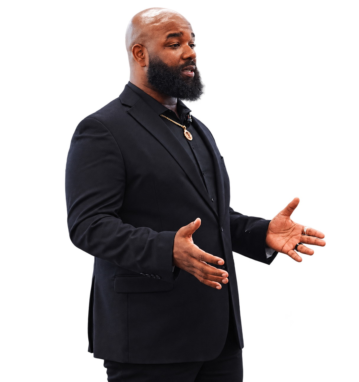 Sylvester Williams speaking in a dark suit